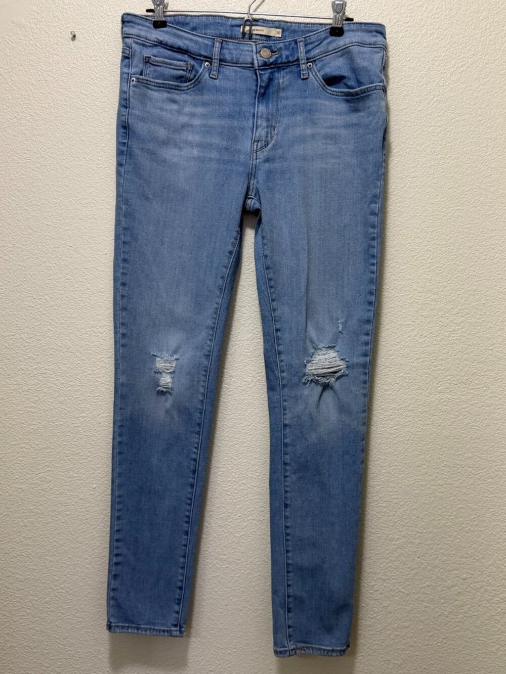 Levi's 711 skinny jeans, lightwash, distressed knees, woman's size 30